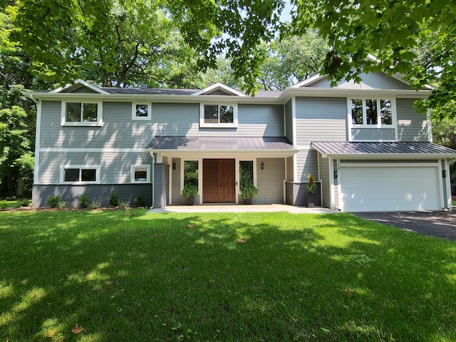 view of front of property featuring a front yard and a garage