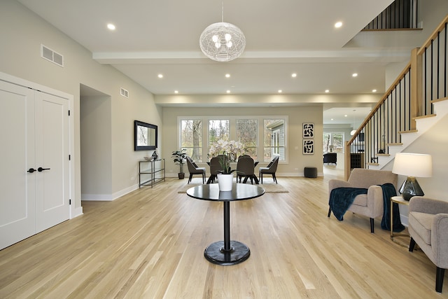 living room featuring a chandelier and light hardwood / wood-style floors