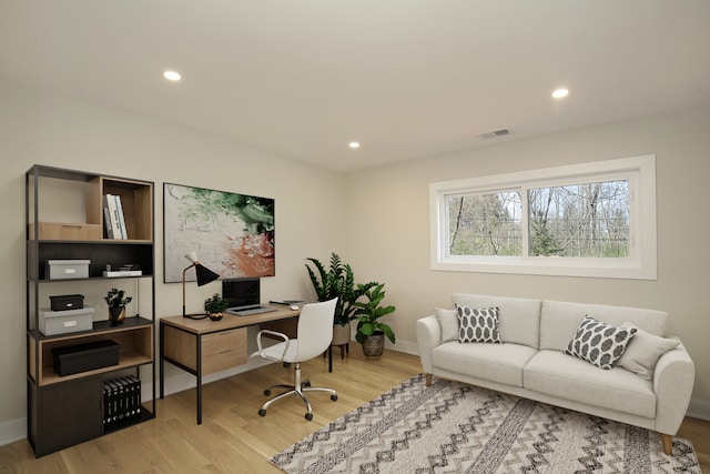 home office with hardwood / wood-style floors