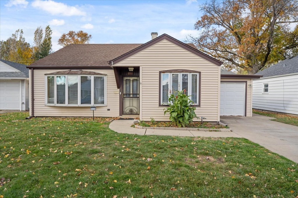 single story home with a garage and a front yard