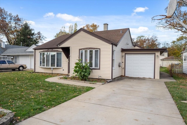 view of front of house with a garage and a front lawn