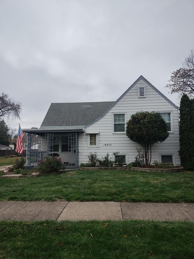 single story home featuring a porch and a front lawn