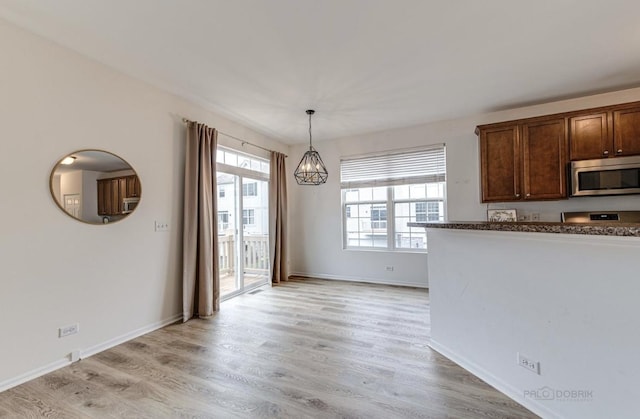 kitchen with a notable chandelier, light hardwood / wood-style floors, and hanging light fixtures