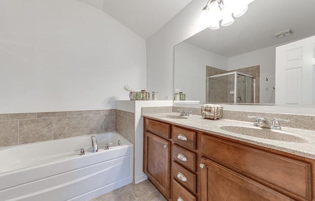 bathroom with tile patterned flooring, vanity, independent shower and bath, and vaulted ceiling