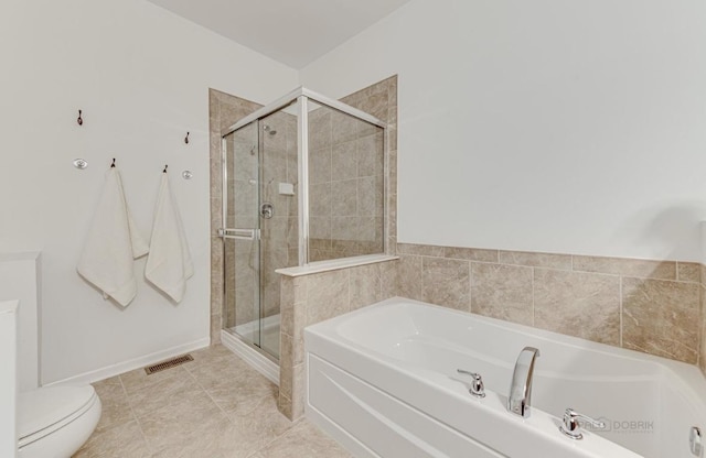 bathroom with plus walk in shower, tile patterned floors, and toilet