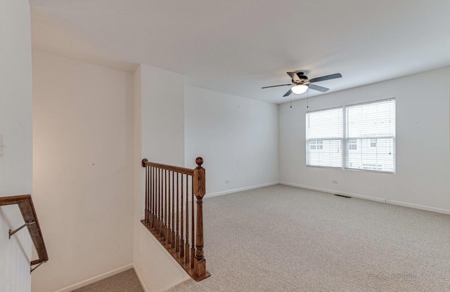 carpeted spare room with ceiling fan