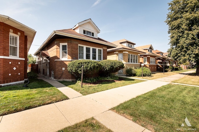 bungalow-style house with a front lawn