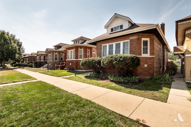 bungalow-style home featuring a front yard