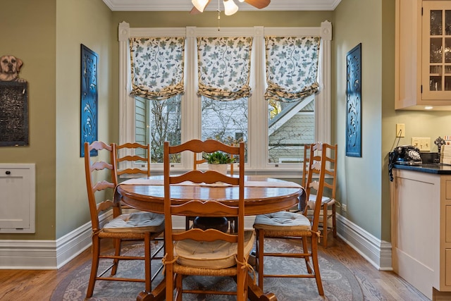 dining area with crown molding, light hardwood / wood-style floors, and ceiling fan