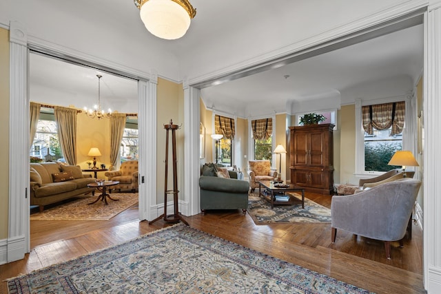 living area with wood-type flooring and a notable chandelier