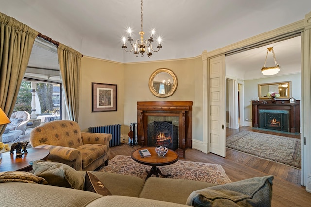 living room featuring a chandelier, radiator heating unit, and dark hardwood / wood-style flooring