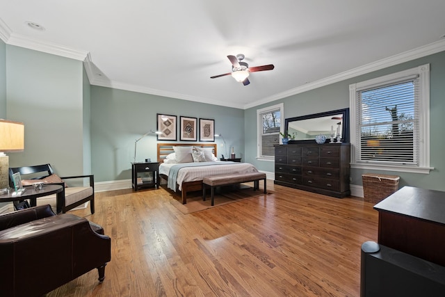 bedroom with ceiling fan, light hardwood / wood-style floors, and crown molding