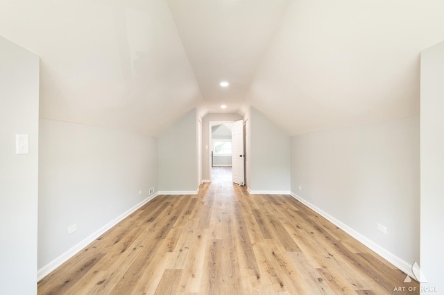 bonus room featuring light hardwood / wood-style floors and vaulted ceiling