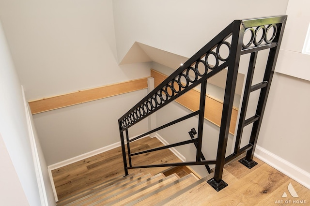 stairway featuring wood-type flooring