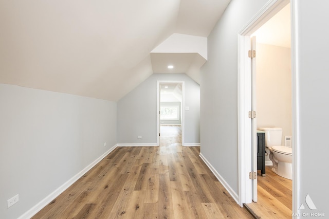 bonus room featuring light wood-type flooring and lofted ceiling