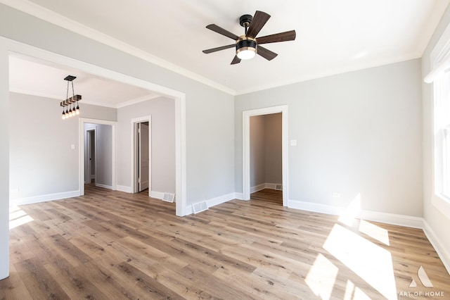 unfurnished room with crown molding, light hardwood / wood-style flooring, and ceiling fan