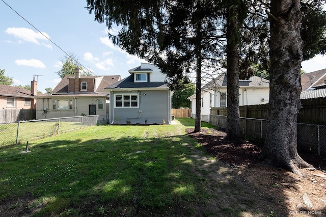 rear view of house with a lawn