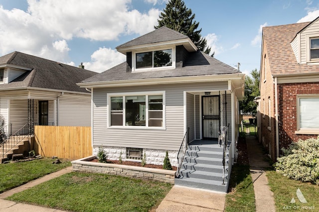 bungalow-style home featuring a front lawn