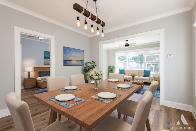 dining space with ceiling fan, crown molding, and dark wood-type flooring