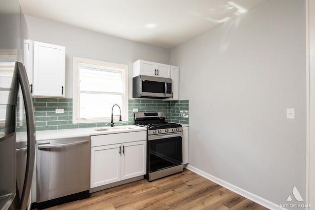 kitchen featuring white cabinetry, appliances with stainless steel finishes, and light hardwood / wood-style flooring