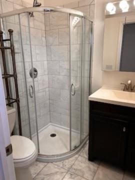 bathroom featuring walk in shower, vanity, and toilet