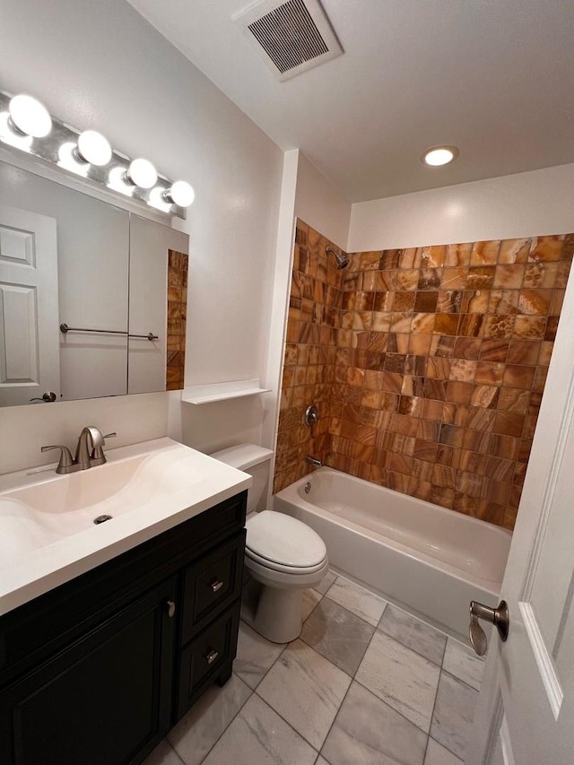 full bathroom featuring tiled shower / bath combo, vanity, and toilet