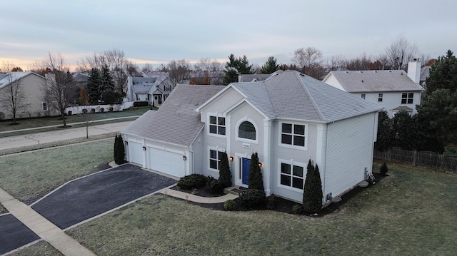 view of front facade with a lawn and a garage