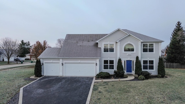 front of property featuring a front lawn and a garage