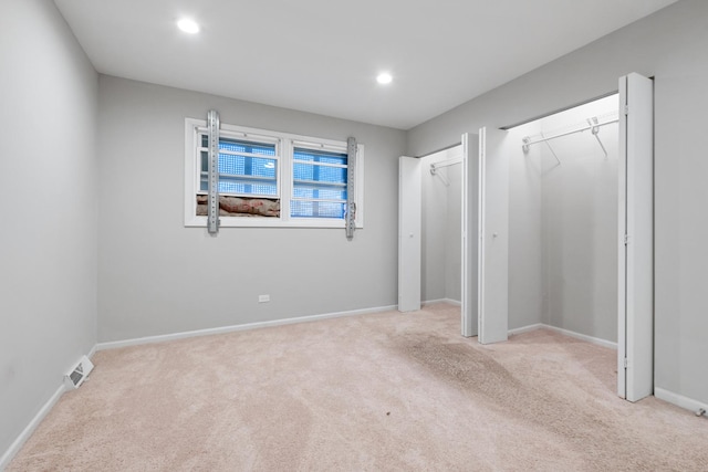 unfurnished bedroom with light colored carpet