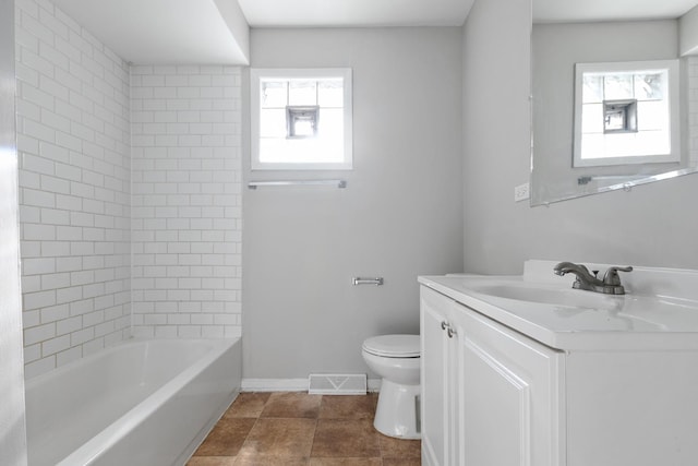 full bathroom featuring tile patterned flooring, vanity, toilet, and tiled shower / bath