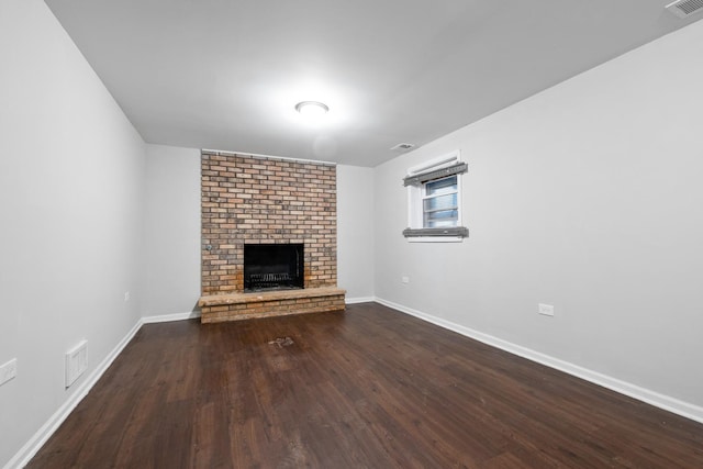 unfurnished living room with a fireplace and dark hardwood / wood-style floors