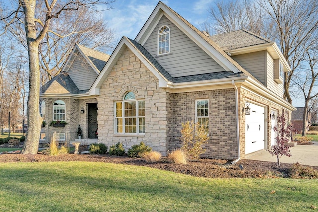 view of front of property featuring a garage and a front lawn