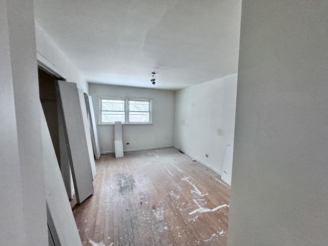 empty room with wood-type flooring