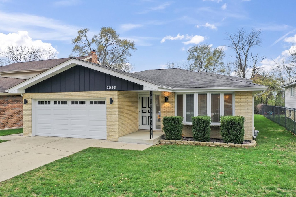 ranch-style home featuring a front yard and a garage