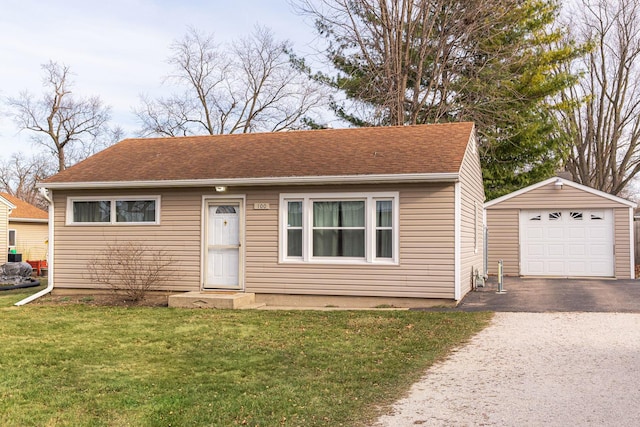 view of front of property with an outbuilding, a front yard, and a garage