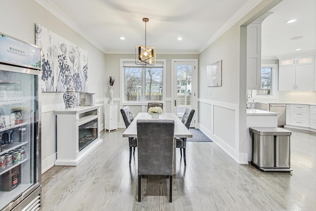 dining area featuring light hardwood / wood-style flooring and ornamental molding