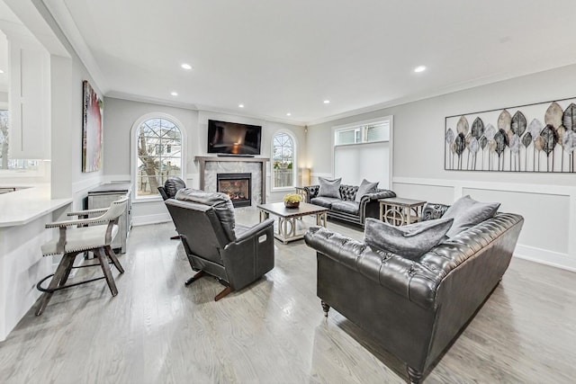 living room with crown molding and light wood-type flooring