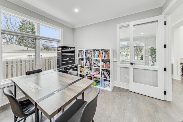 home office featuring light wood-type flooring and ornamental molding