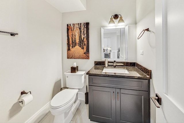 bathroom featuring tile patterned flooring, vanity, and toilet