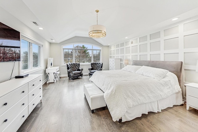 bedroom with hardwood / wood-style floors, vaulted ceiling, and multiple windows