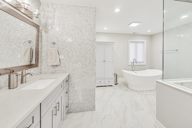 bathroom featuring vanity and a tub