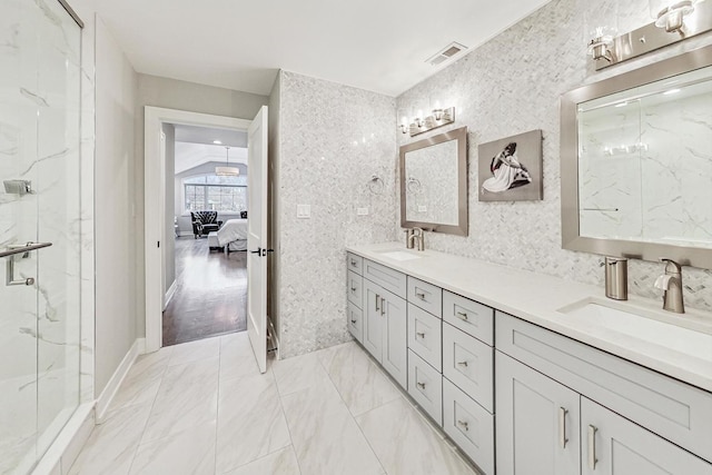 bathroom featuring vanity, walk in shower, and vaulted ceiling