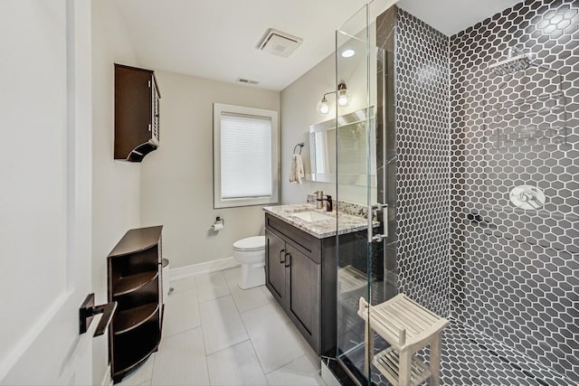 bathroom with walk in shower, vanity, and toilet