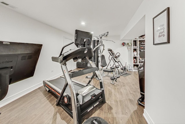 workout room with hardwood / wood-style flooring