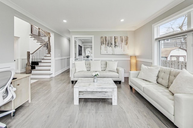 living room with hardwood / wood-style flooring and ornamental molding