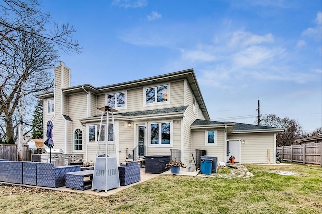 rear view of property with an outdoor hangout area, a patio area, and a lawn