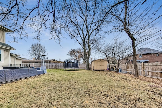 view of yard featuring a storage shed and a trampoline