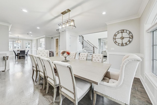 dining space with wood-type flooring and crown molding