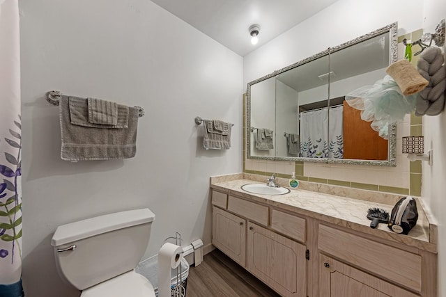 bathroom featuring vanity, hardwood / wood-style flooring, toilet, and curtained shower