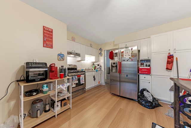 kitchen with white cabinets, sink, light hardwood / wood-style flooring, appliances with stainless steel finishes, and tasteful backsplash